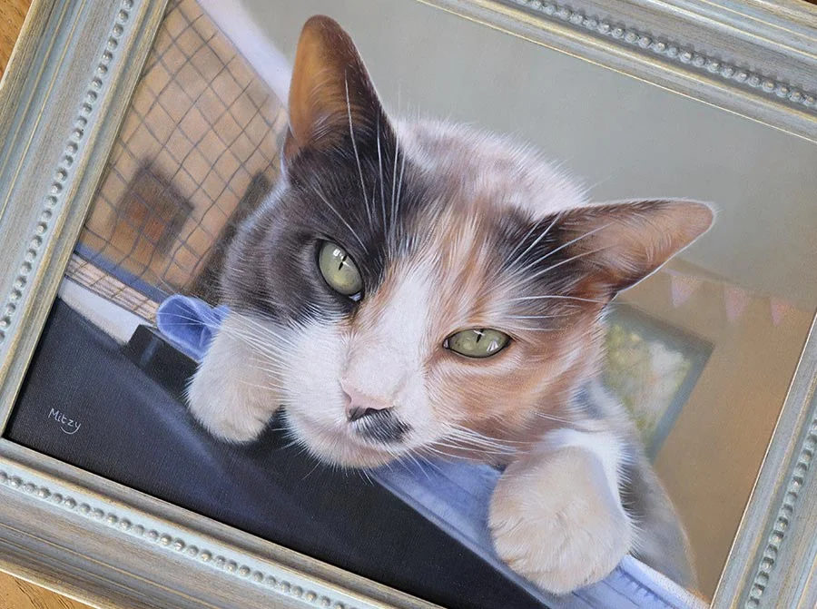 Mitzy's framed cat portrait in oils, showing the texture of the canvas and frame.