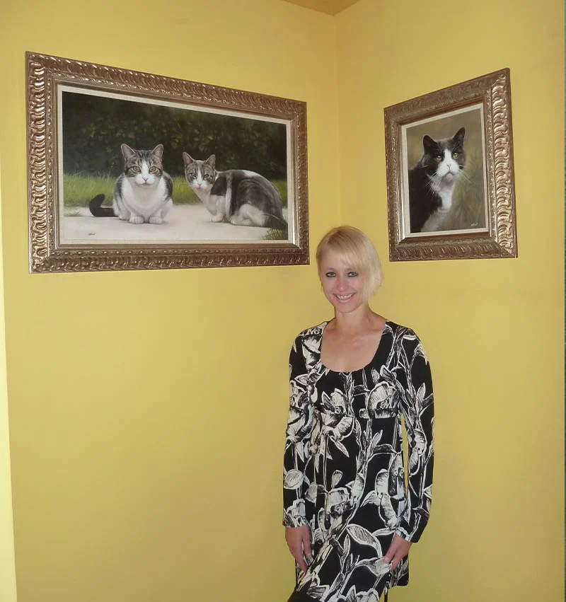 Client Amanda proudly displaying Purdy's framed cat oil painting.