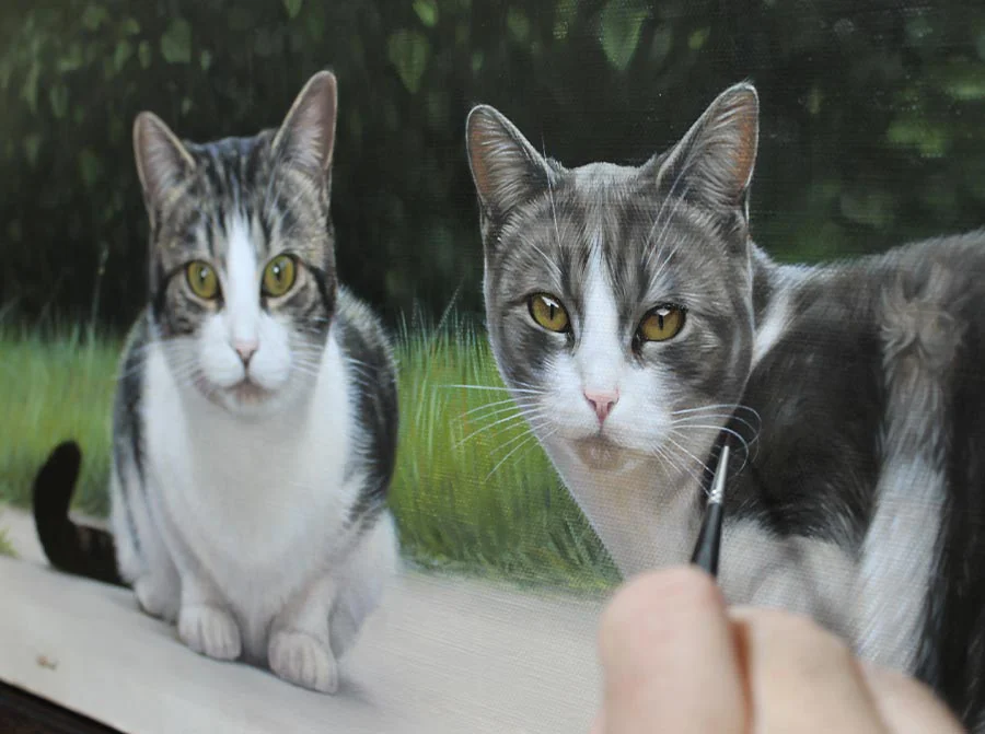 Artist Nicholas Beall painting the two cats, Milly and Molly, in oils in his studio.