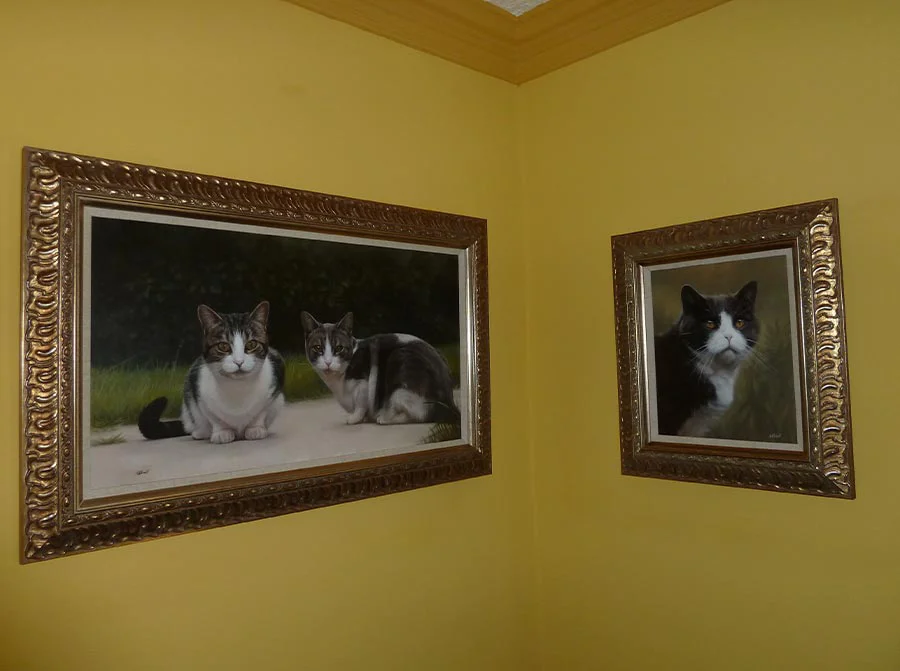 Framed oil portrait of Milly and Molly hanging elegantly on a wall.