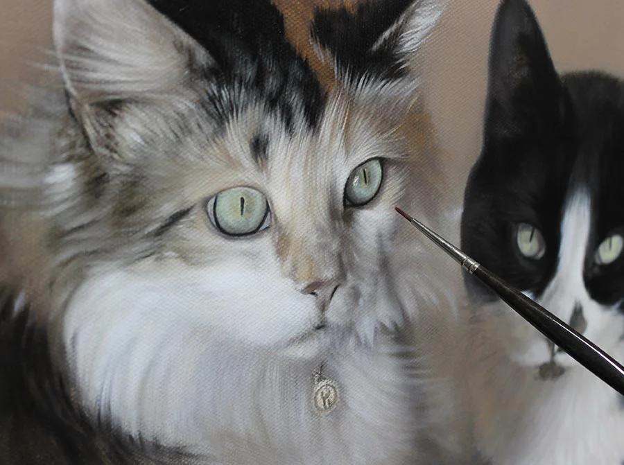 Ginger and Maggie's cat portrait on easel, showing detailed work on features.