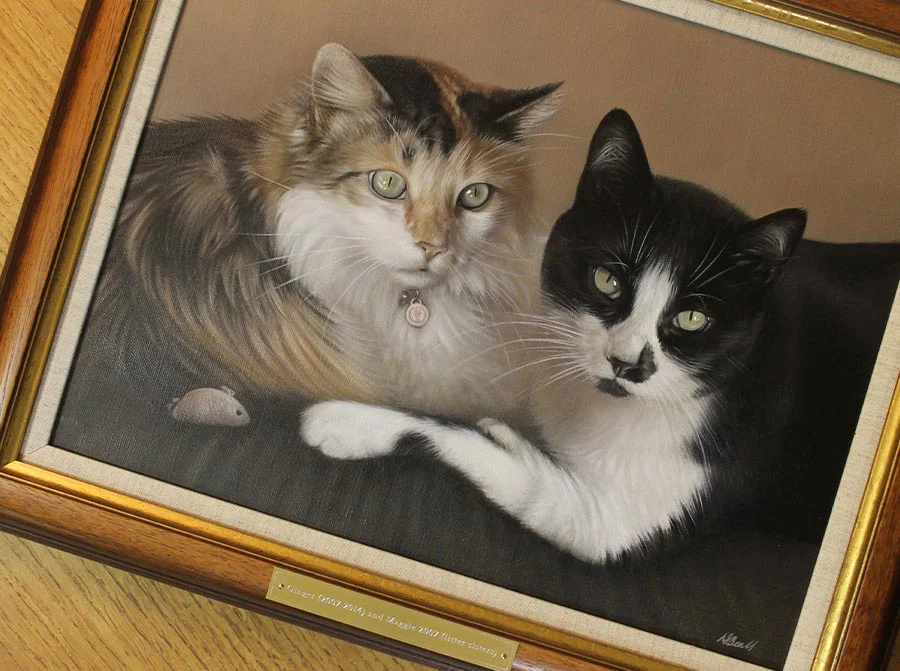 Framed cat portrait of Ginger and Maggie displayed elegantly on a wall.