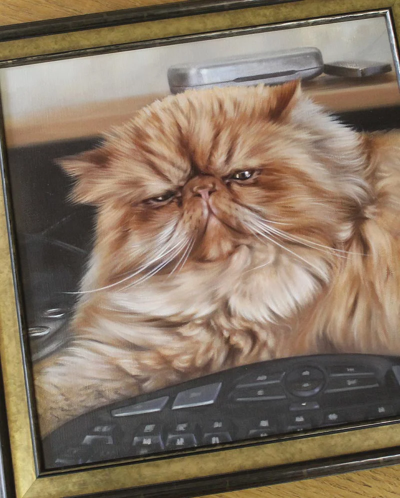 Oil cat portrait of Puff displayed in a home setting.