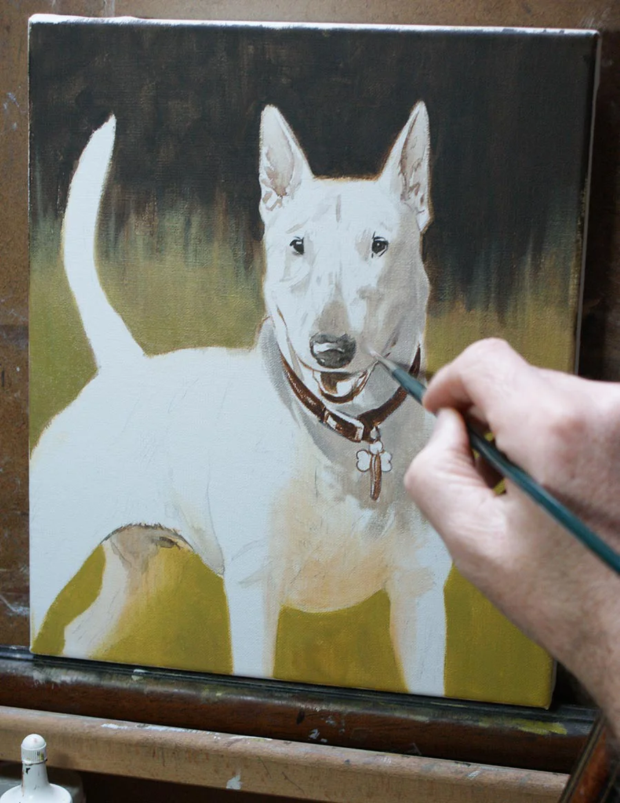 Framed oil portrait of Millie the Bull Terrier, hanging on a wall.