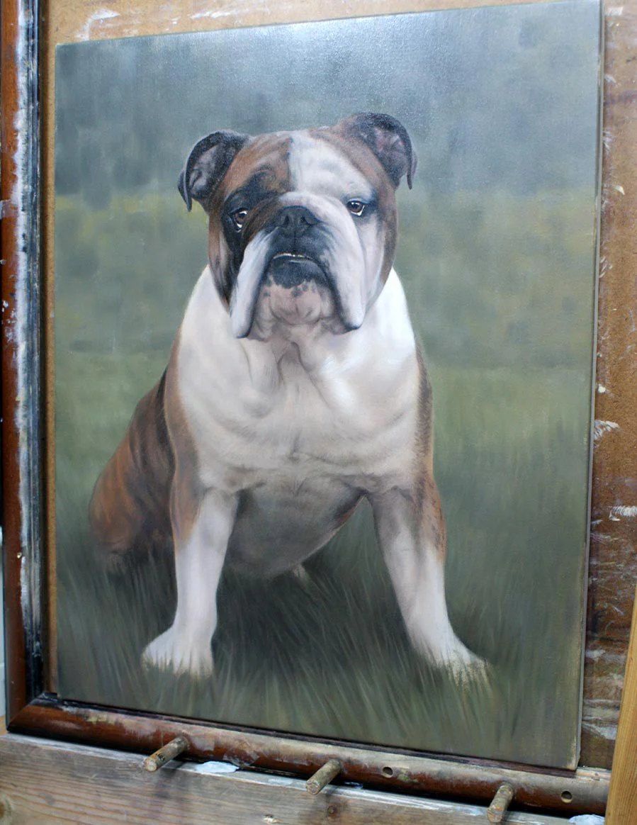 Oil painting of Winston the Bulldog displayed on an artist's easel in the studio.