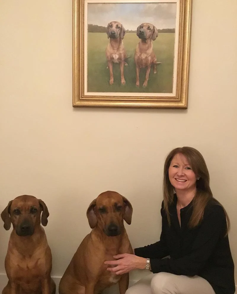 Rhodesian Ridgeback Dogs Beside Their Portrait, a true likeness The actual Rhodesian Ridgeback dogs, Amba and Maddie, sitting beside their oil portrait