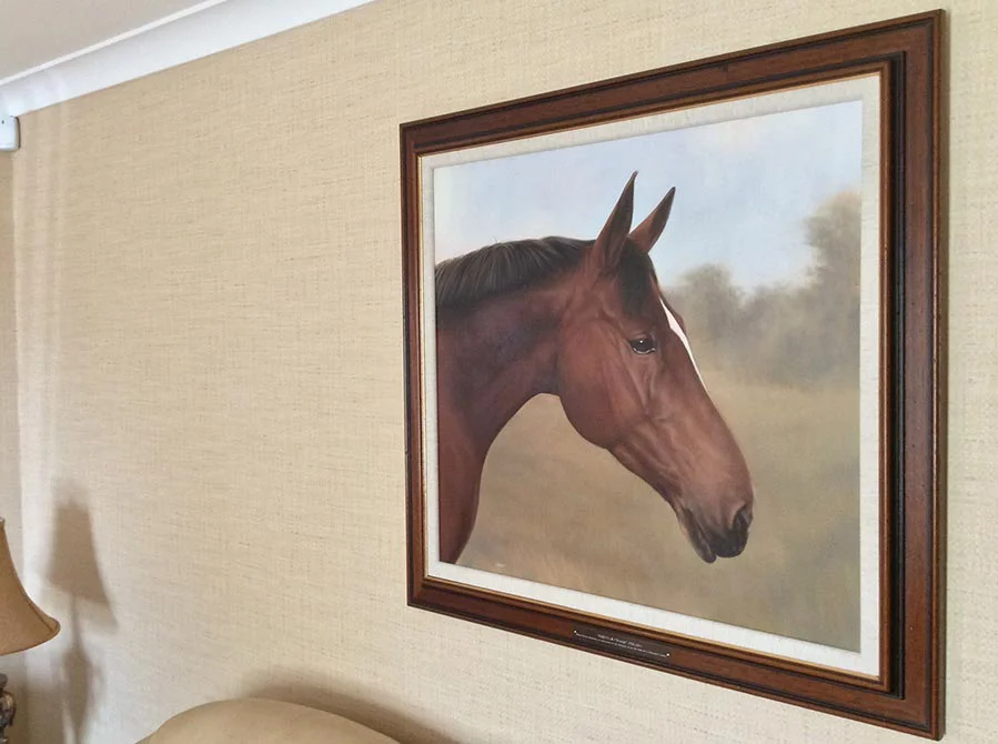 Client Displaying Framed Horse Portrait Client displaying the framed horse portrait of Tequilla in her home.