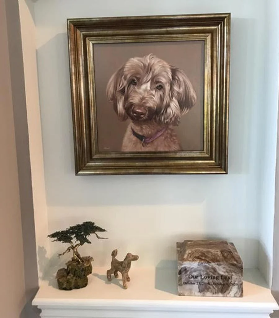 Memorial oil portrait of Lexi by Nicholas Beall with framed ashes A memorial oil portrait of Lexi, a beloved dog, displayed alongside framed ashes, creating a touching tribute.