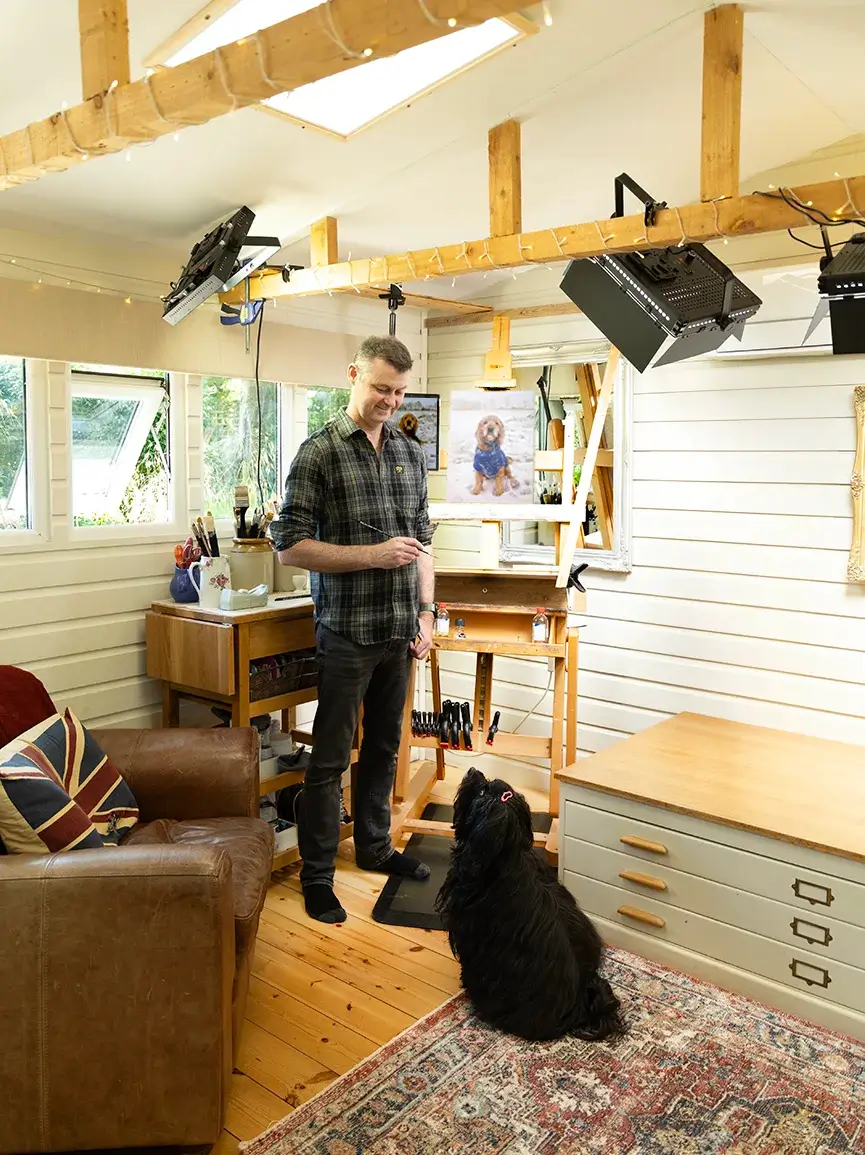 Nicholas Beall in his studio with Lily