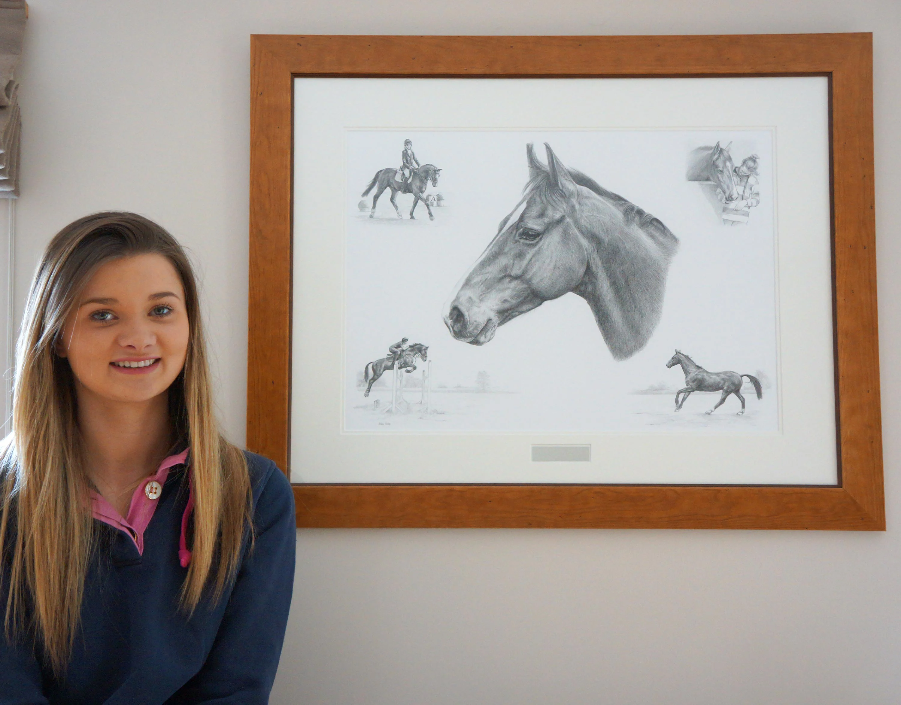 Happy client, Olivia, proudly holding her framed pencil portrait montage of her horse, Casanova, featuring various riding and jumping scenes.