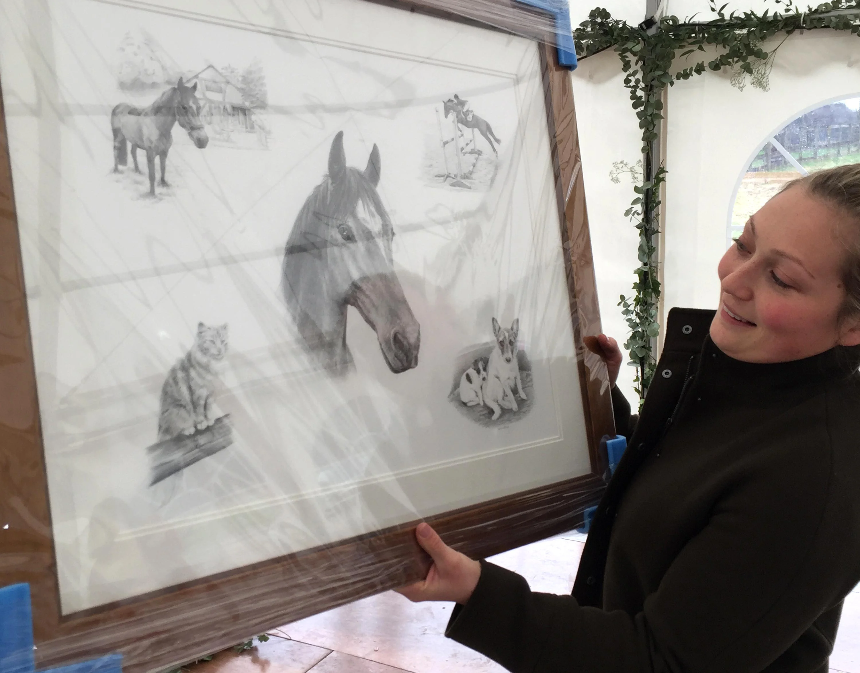 A beautifully framed pencil montage portrait by Melanie Phillips, showcasing a horse, two Jack Russell dogs, and a cat, ready for display.
