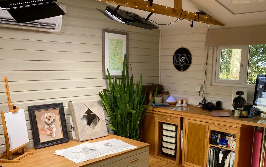 Studio Lighting and Ambiance in Welsh Winter The art studio interior bathed in warm, inviting light from professional lamps and decorative fairy lights during a dark Welsh winter.