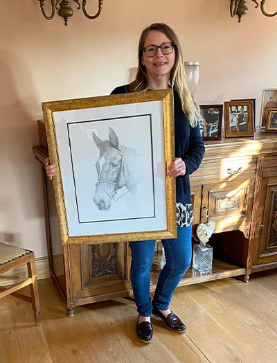 Client Phil Purssey's Horse Portrait Testimonial for Freya Client Phil Purssey's daughter reacting emotionally to her framed pencil portrait of Freya the horse, highlighting the portrait's accuracy.