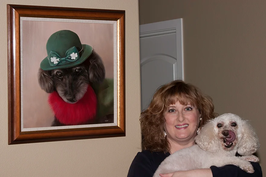 Tracy Maguire's Testimonial for Curly's Portrait Client Tracy Maguire's dog Sarah posing somewhat reluctantly next to a framed portrait of Curly, displayed in their home.