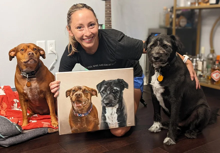 Client Brian's family and pets with their new oil portrait Happy client Jen, with her dogs Moose and Shadow, proudly displaying their custom pet portrait oil painting.